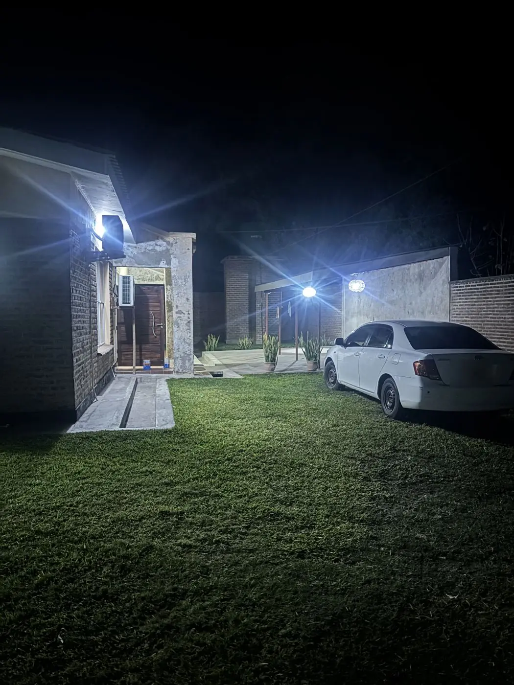 Exterior at night with wall-mounted security lighting