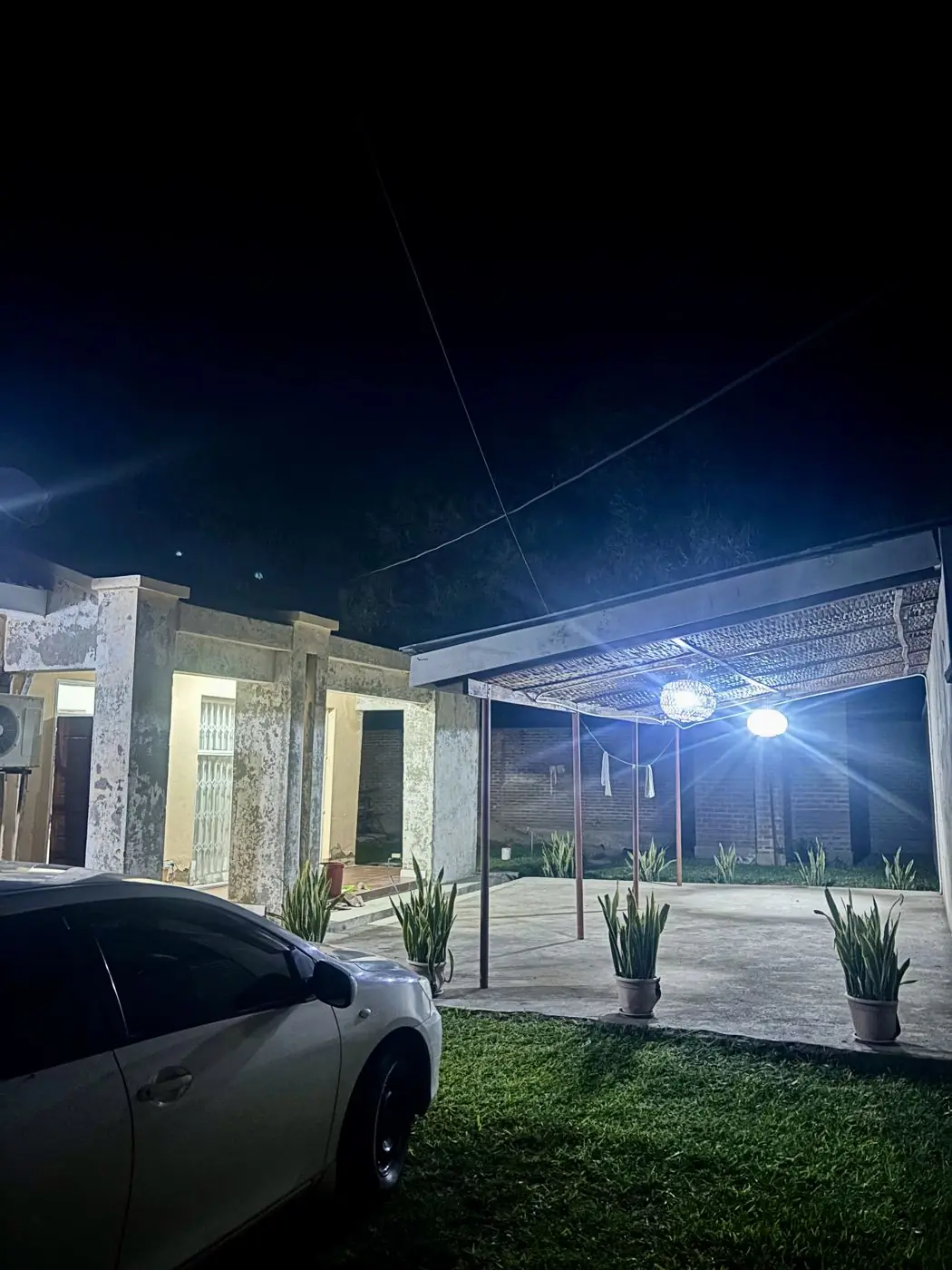 Covered patio and walkway lit at night